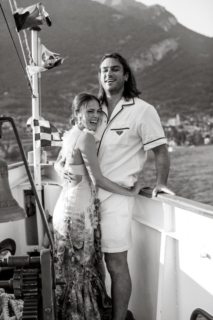 Couple hug on deck of boat on Lake Como before their wedding.