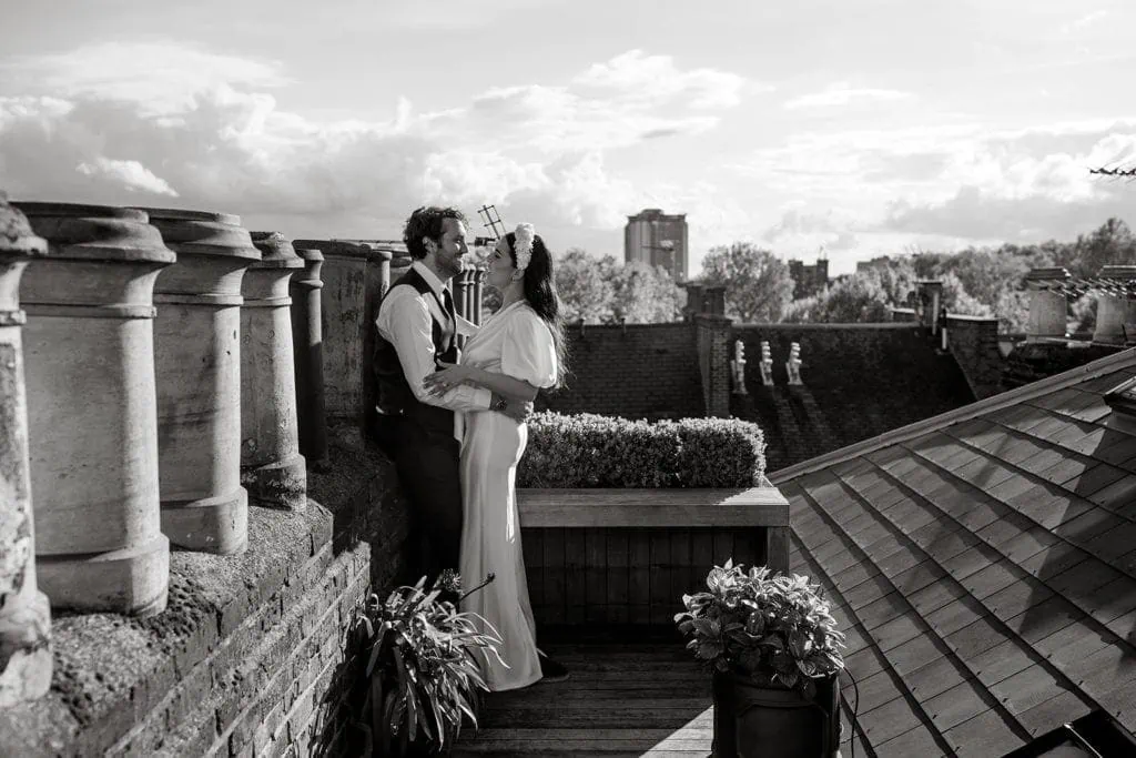 Bride and groom embrace on London rooftop after getting married