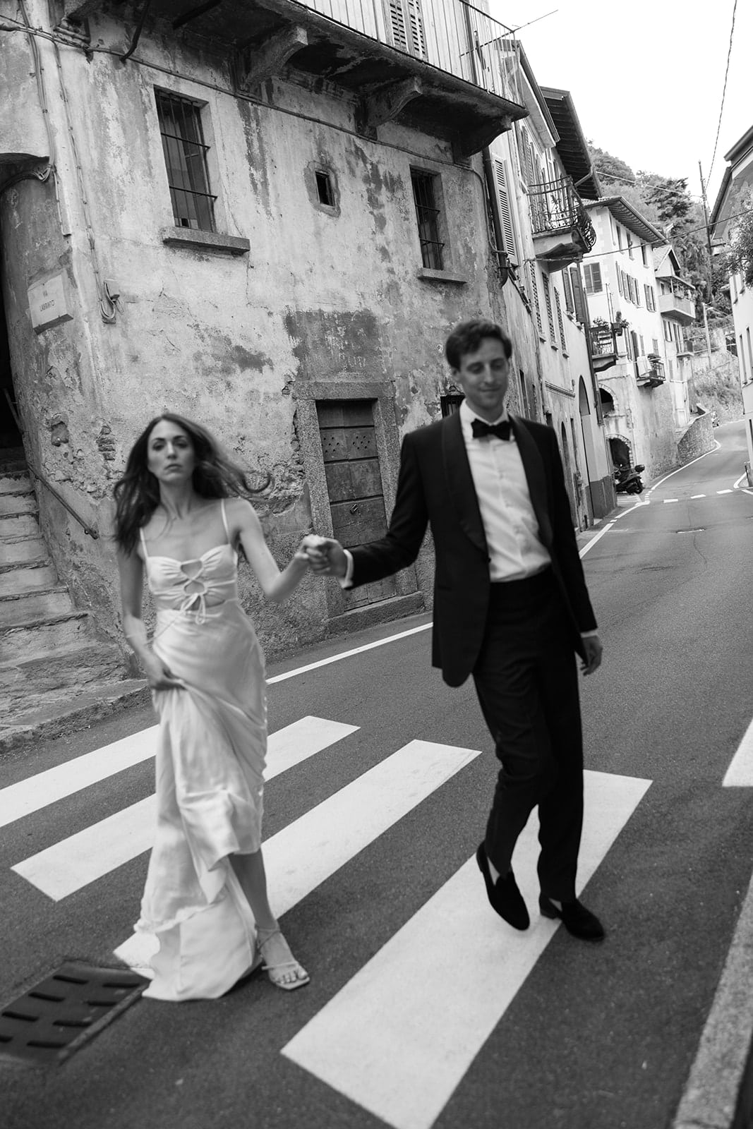 Couple walk down the streets in a town in Lake Como