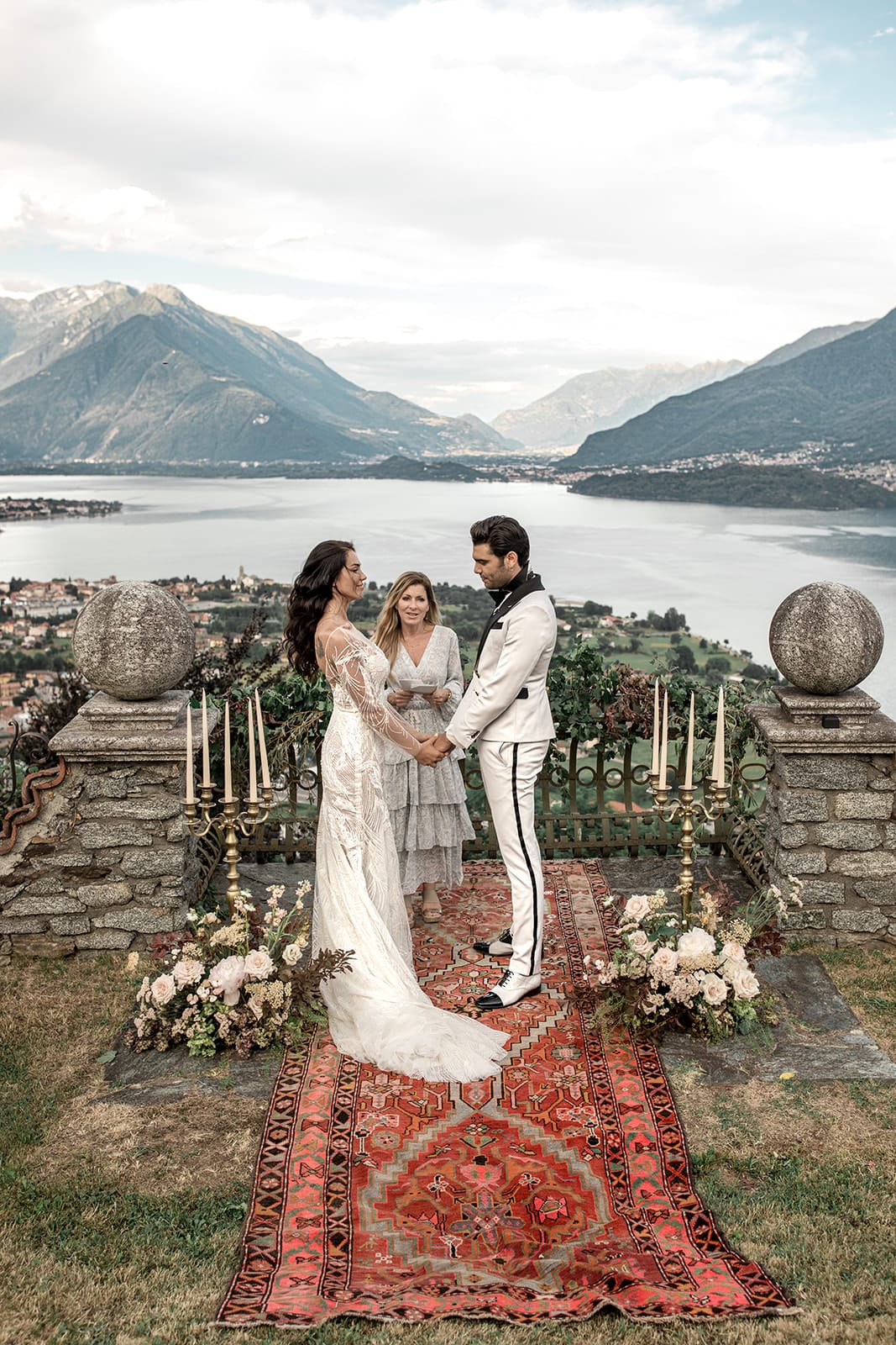 Bride and groom hold hands during vow renewal at Lake Como