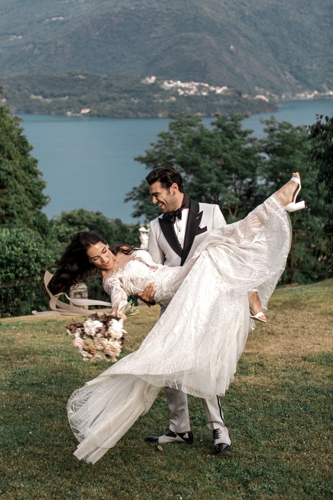 Groom dances with bride in Lake Como