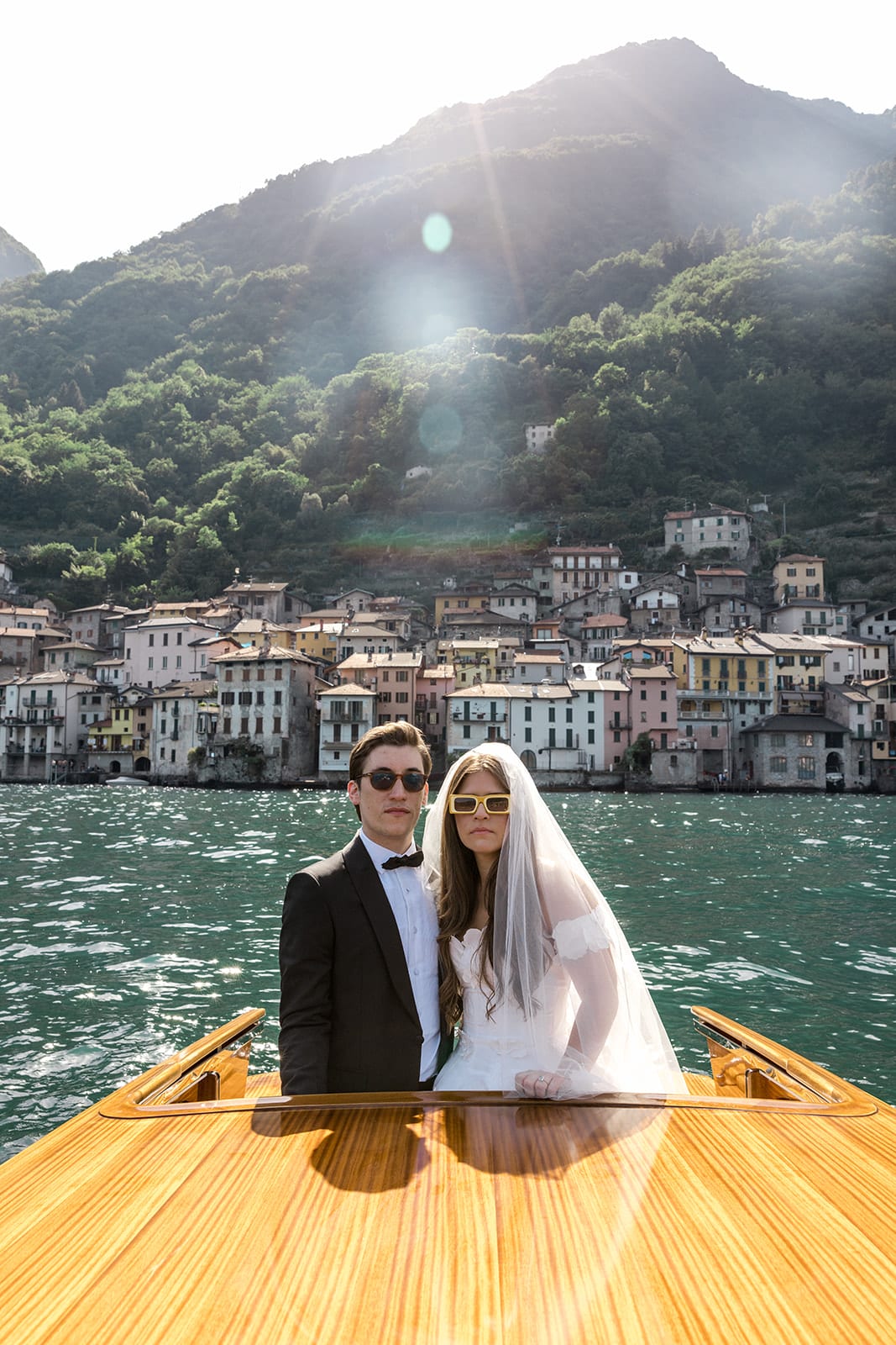 Bride and groom take riva across Lake Como, Italy