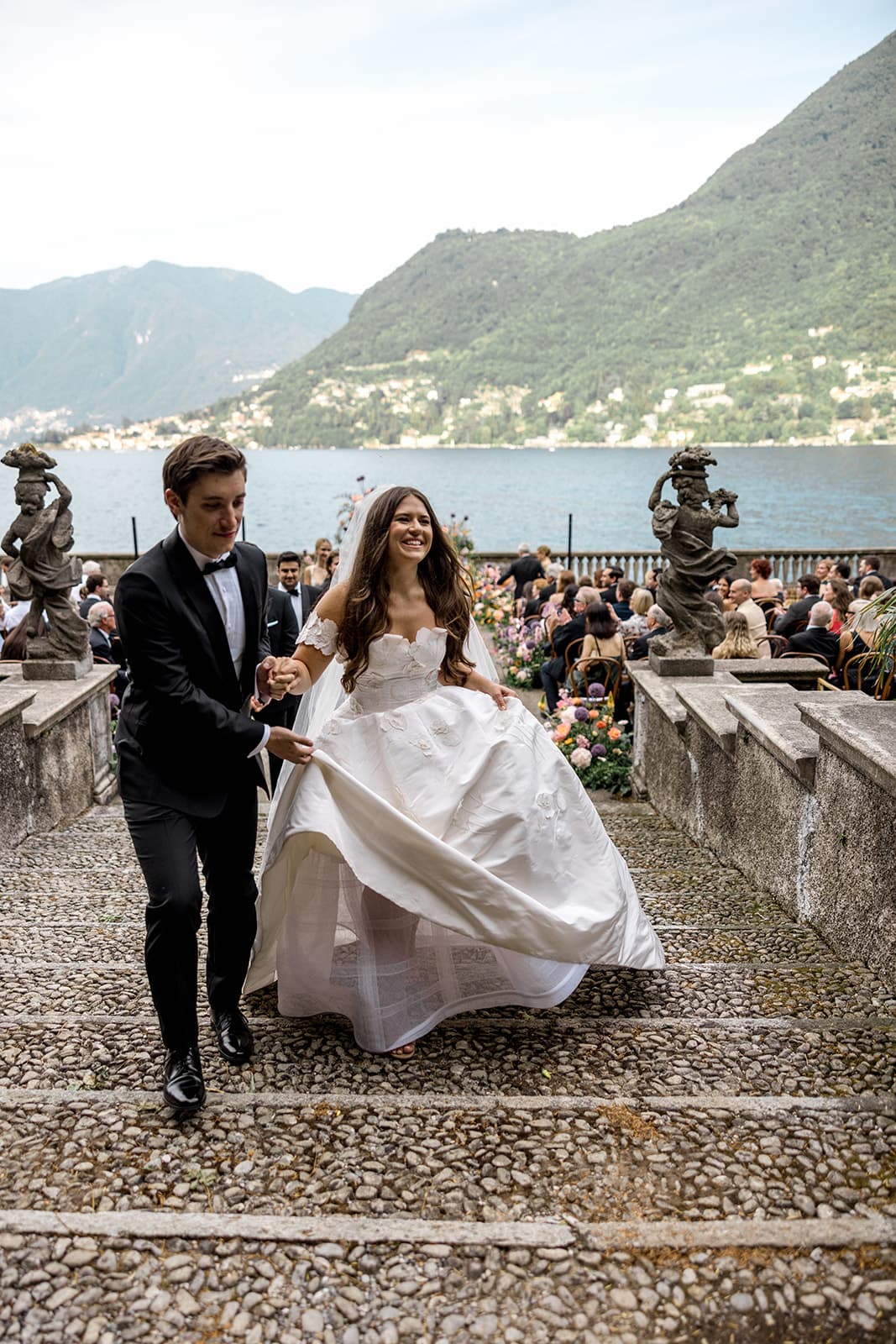 Bride and groom walk down ceremony aisle at Lake Como