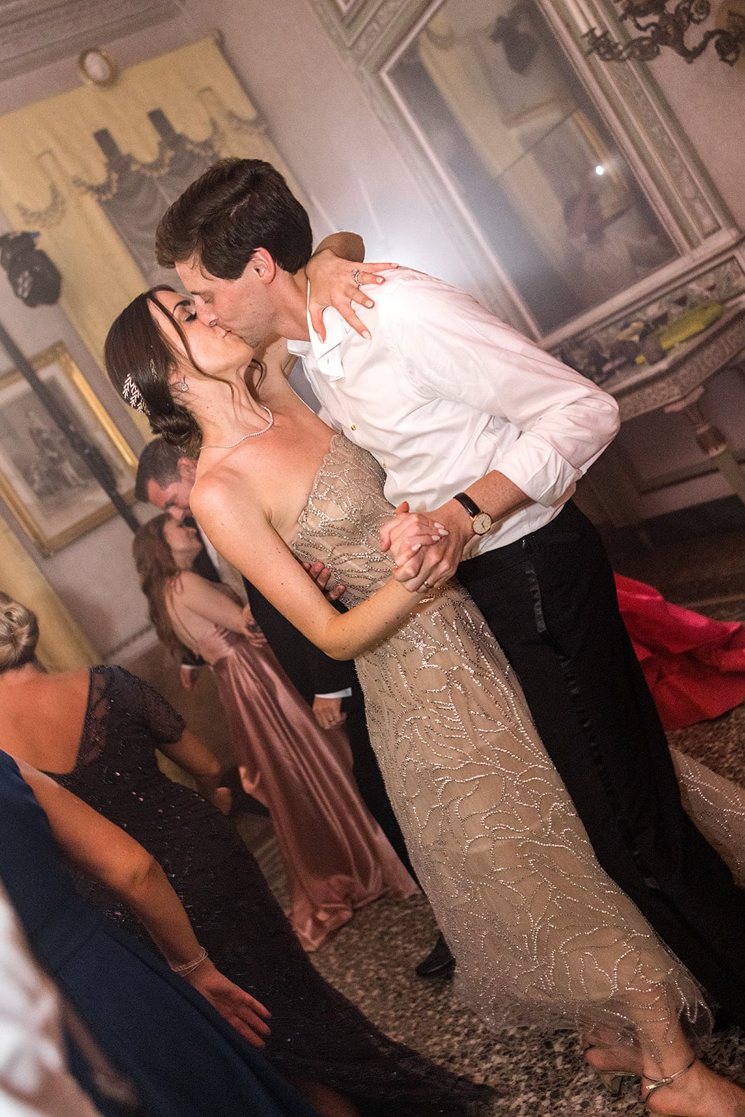 Bride and groom kiss during Villa Pizzo reception