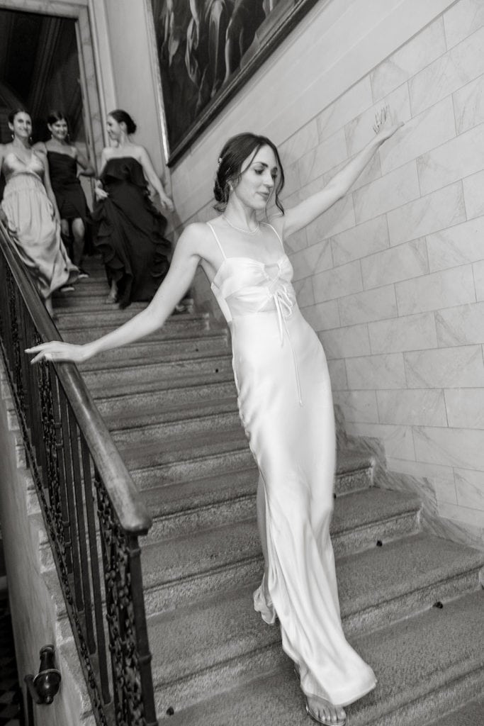 Bride walks downstairs in Shona Joy dress