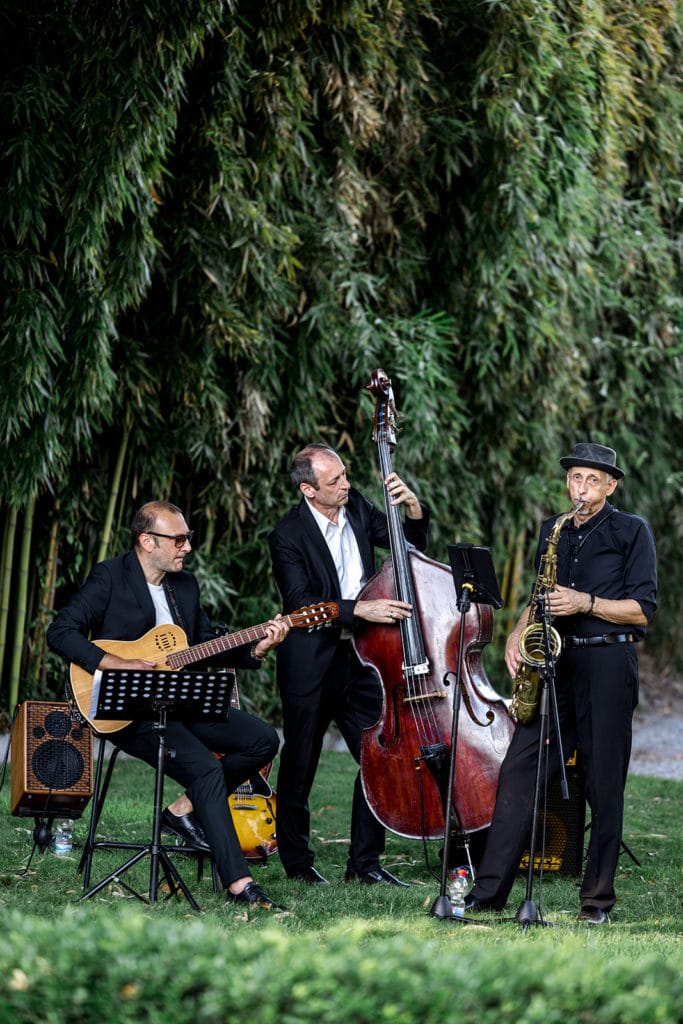 Live trio band plays during cocktail hour at wedding