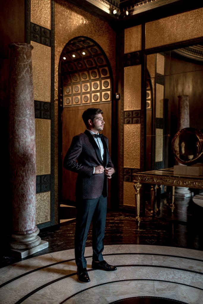 A model groom stands in the Villa Clara lobby