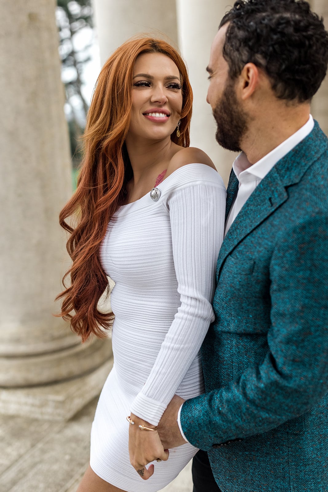 Woman smiles at man during engagement photos, bay area