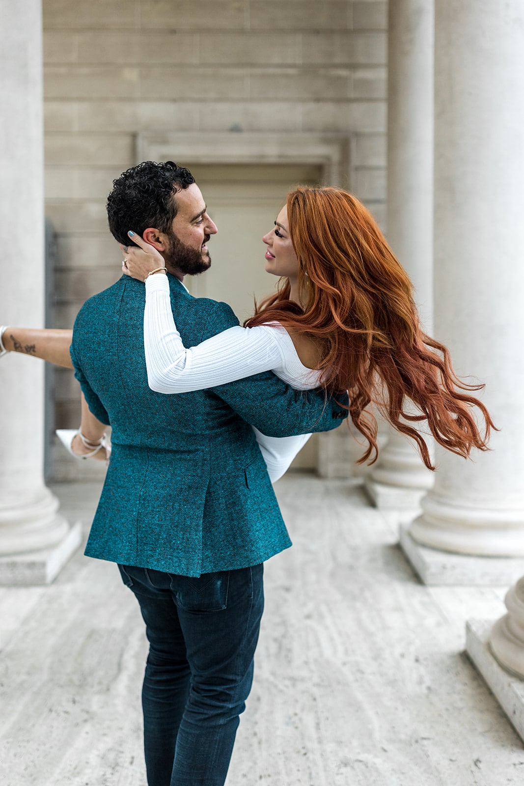 Man carries woman during engagement photos in the bay area