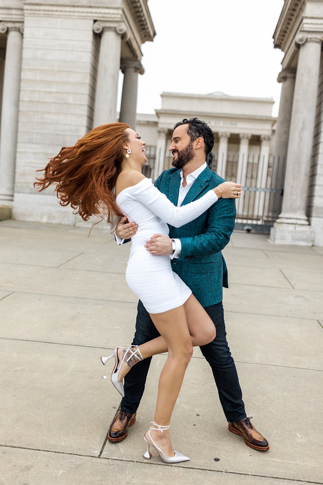 Man and woman dancing during bay area engagement session