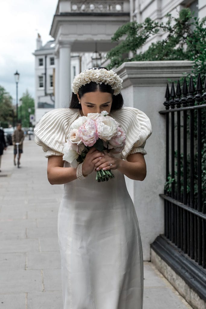 Bride smells her peony bridal bouquet on London wedding day