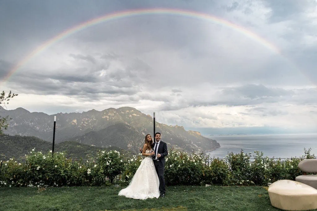Bride and groom outside with rainbow