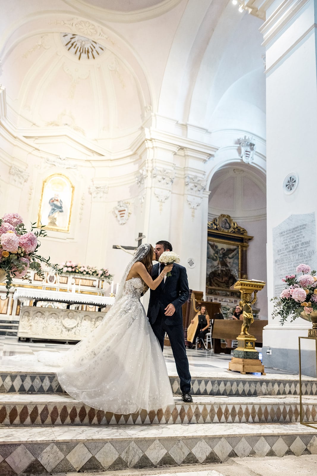 Bride and groom kiss inside Duomo di Ravello ceremony