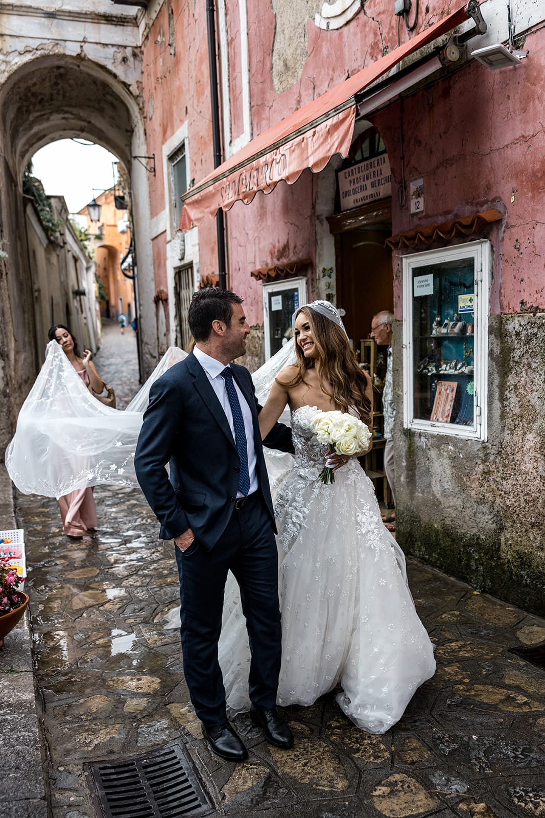 Bride and groom walk streets after Ravello Italy wedding ceremony