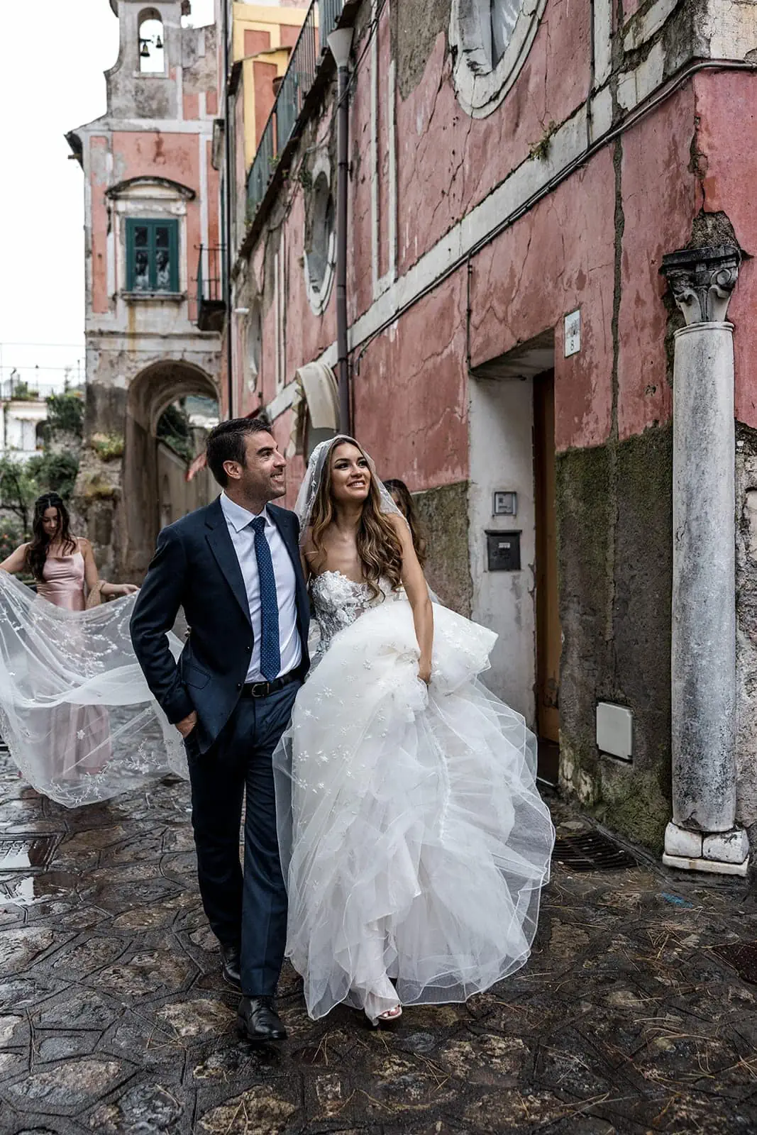 Bride and groom walk in streets of Ravello Italy after wedding