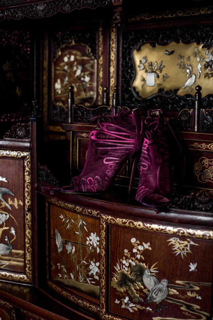 Merlot-colored heels for a bride on a dresser in a Villa Clara suite