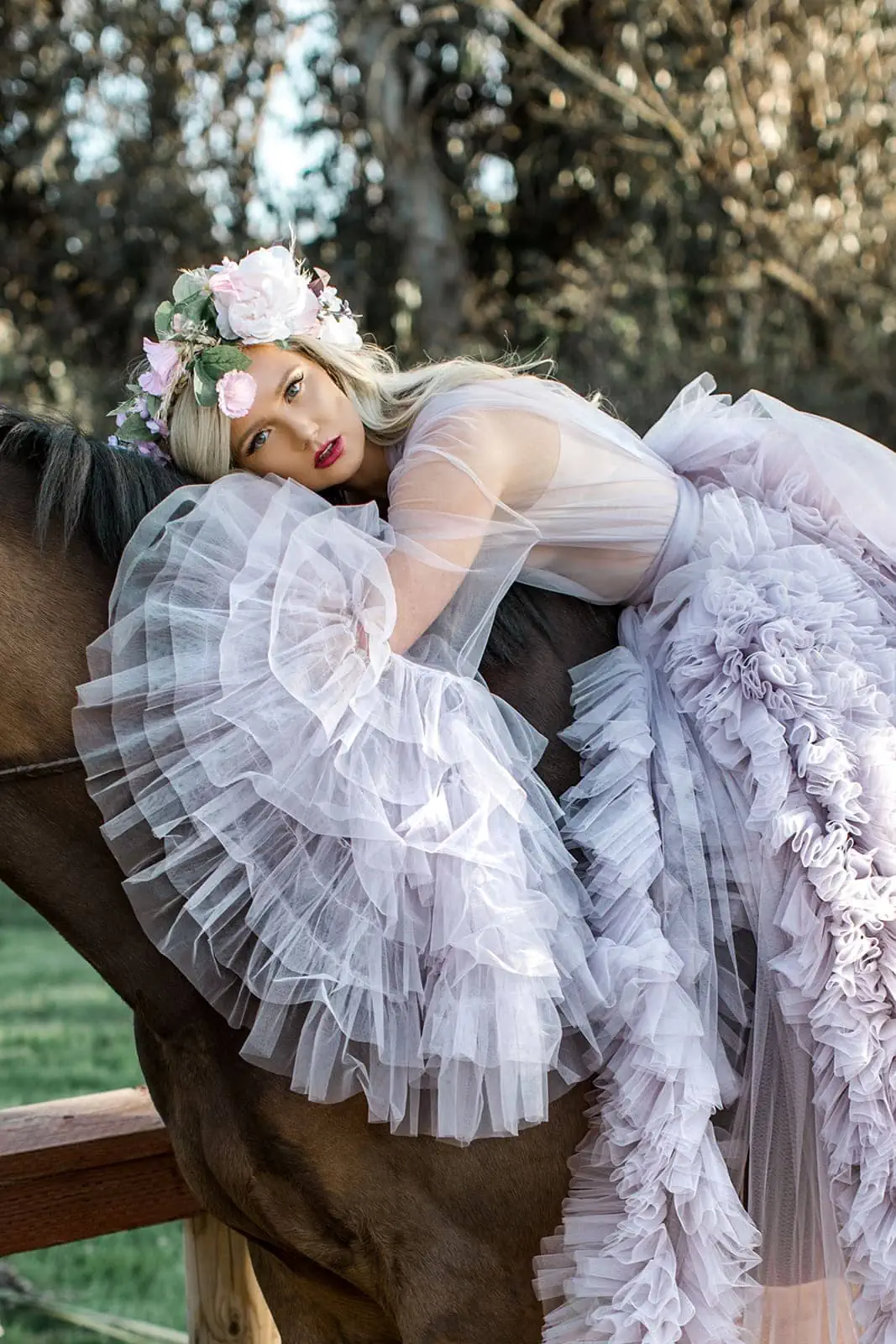 Model sits atop horse in lavender luxury robe