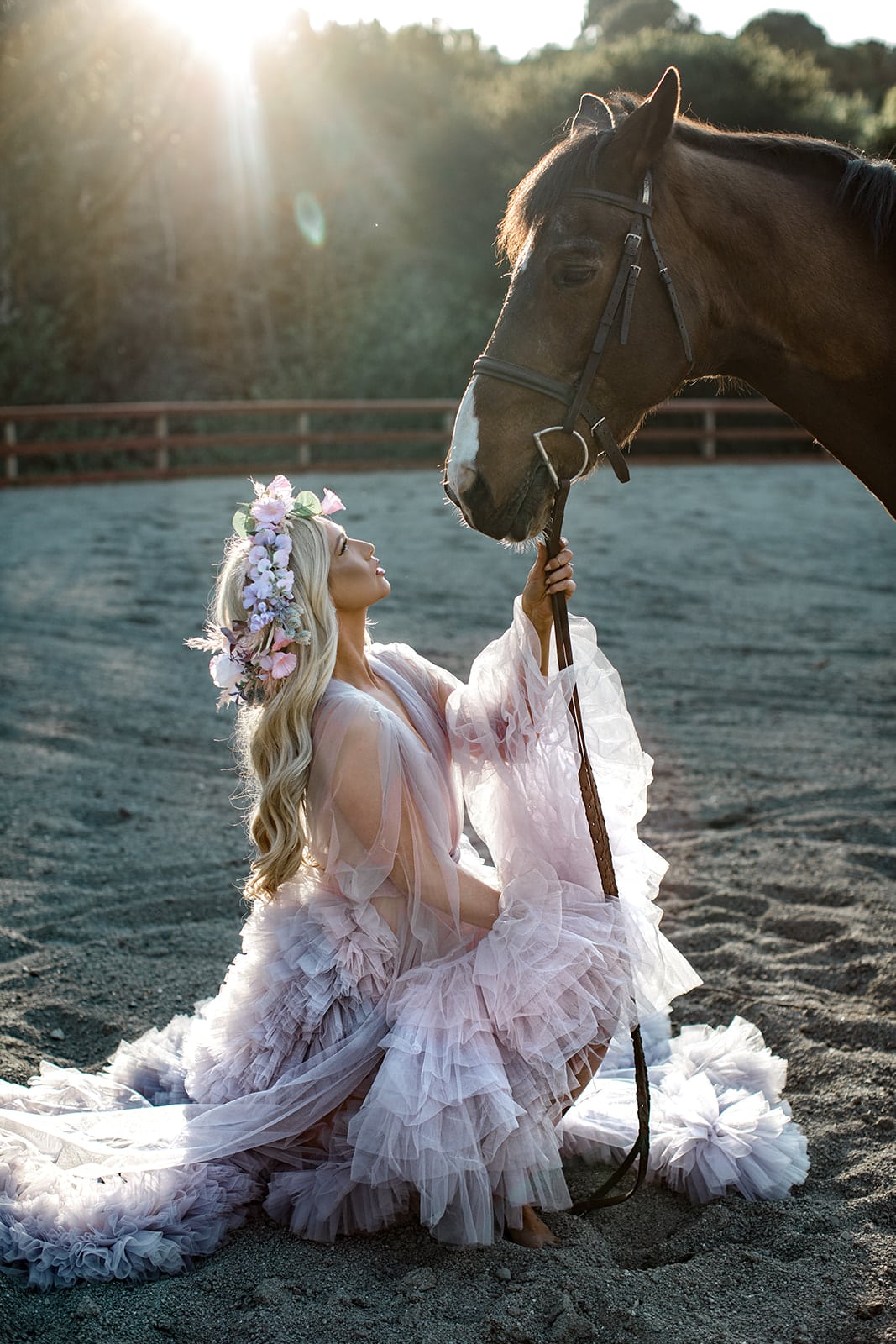 Model sits in lavender bridal robe while holding horse's reins
