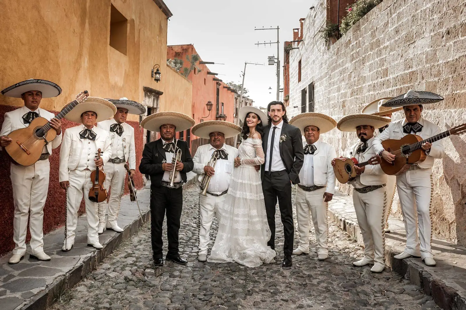 Bride and groom stand with mariachi band after wedding in San Miguel de Allende