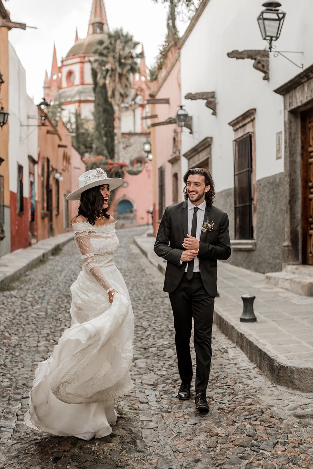 Bride and groom walk streets after Mexico elopement