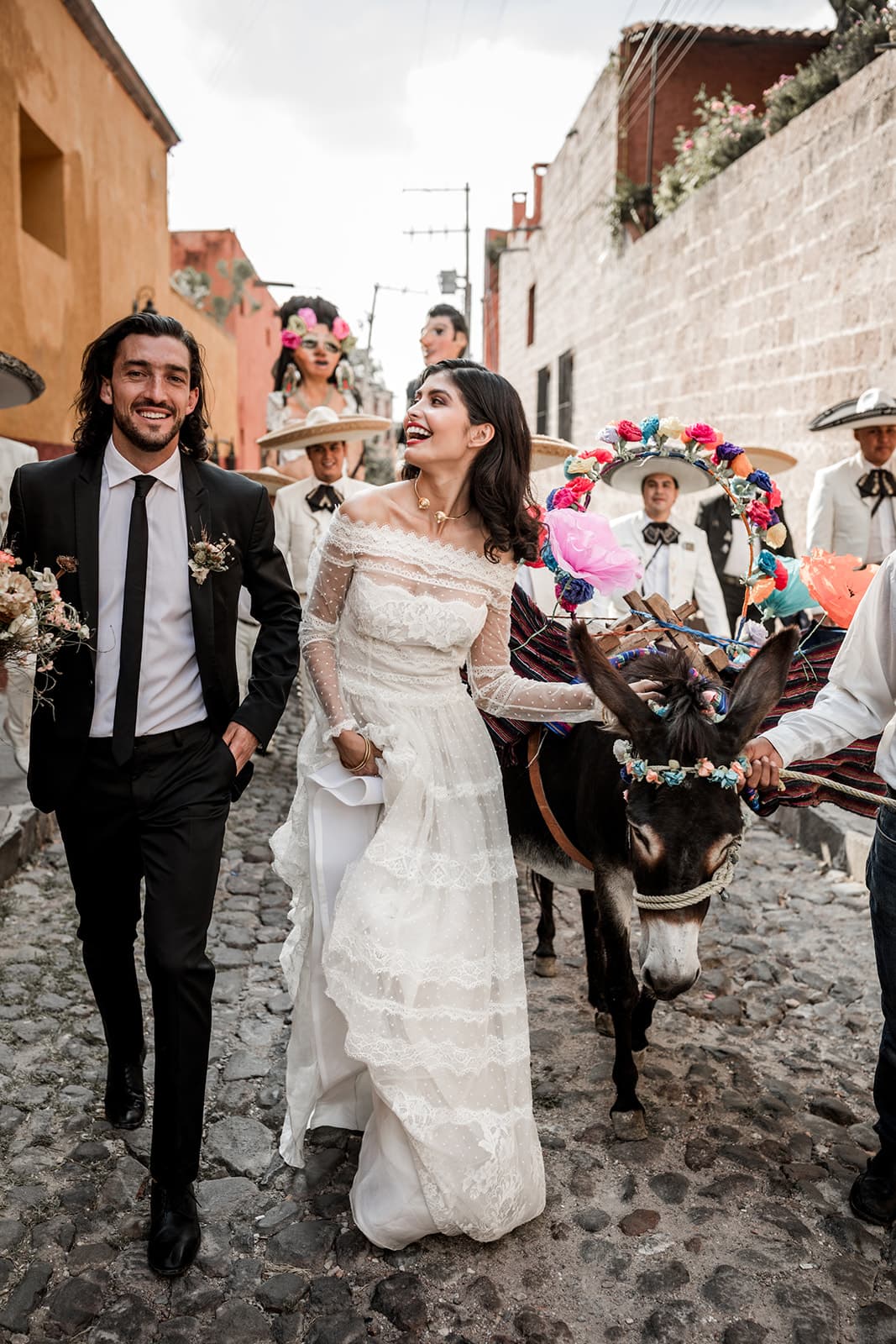Bride and groom walk for traditional San Miguel de Allende wedding parade