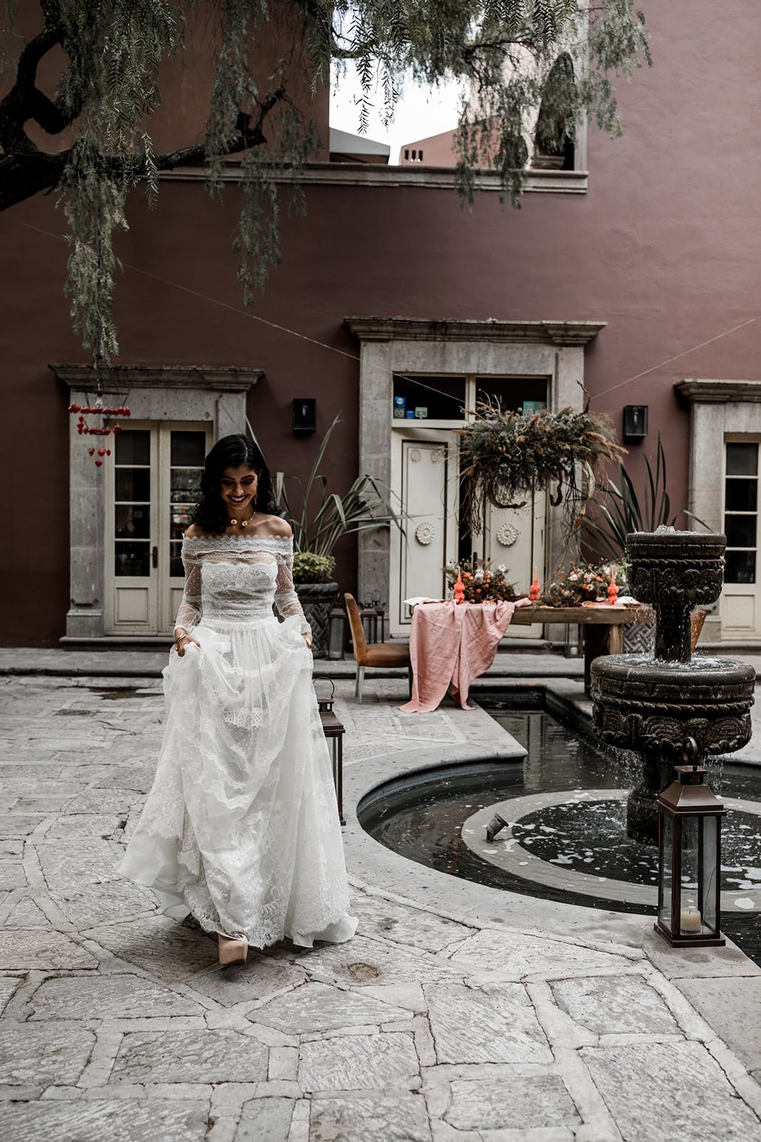Bride walks in Hotel Nena courtyard for wedding reception