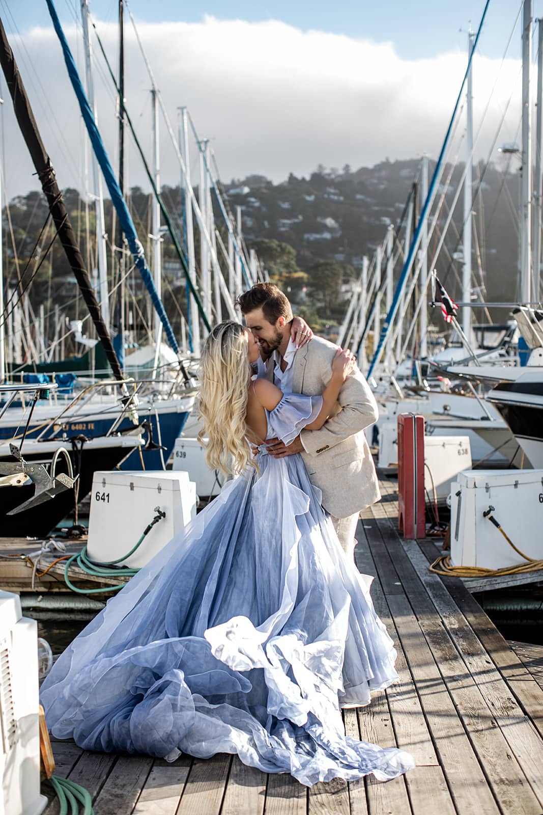 Couple kiss on sailing docks for San Francisco engagement photos