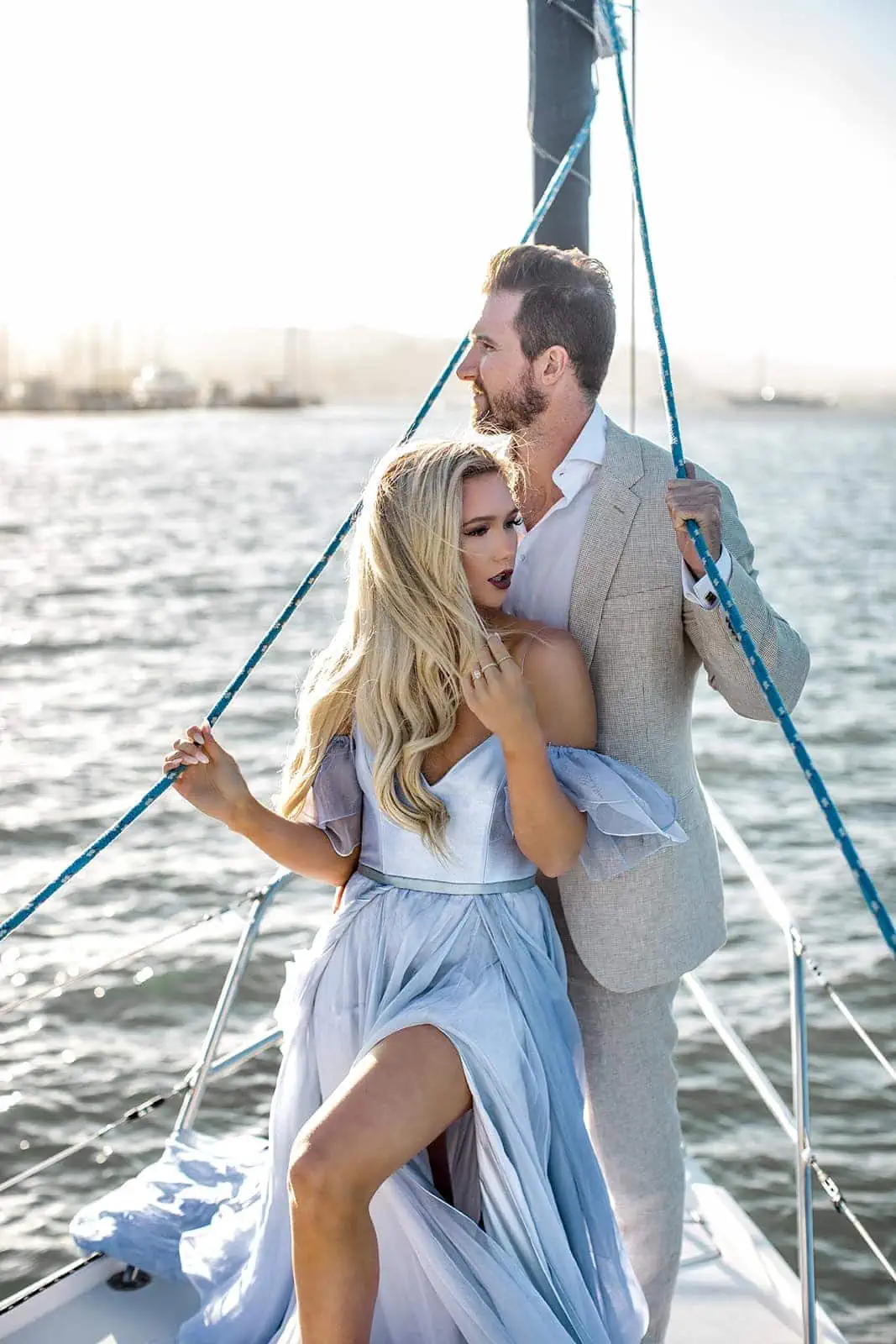 Couple pose on sailboat during Bay Area engagement photos