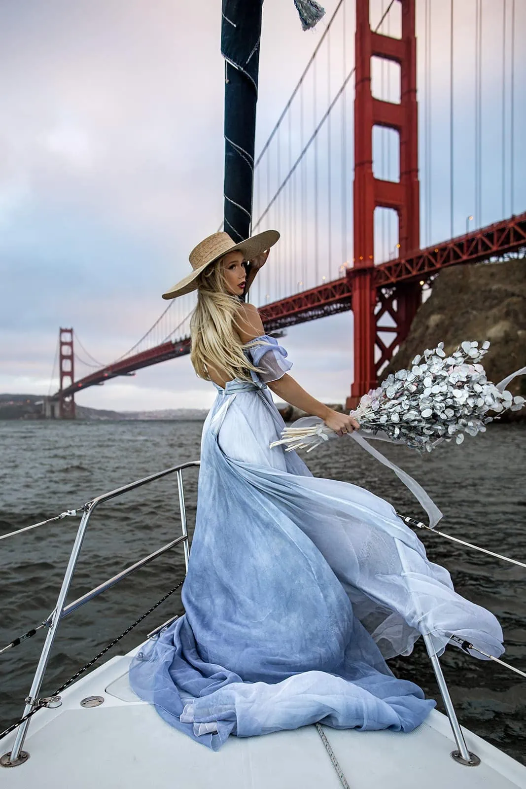 Woman wearing Leanne Marshall bridal dress on sailboat in San Francisco