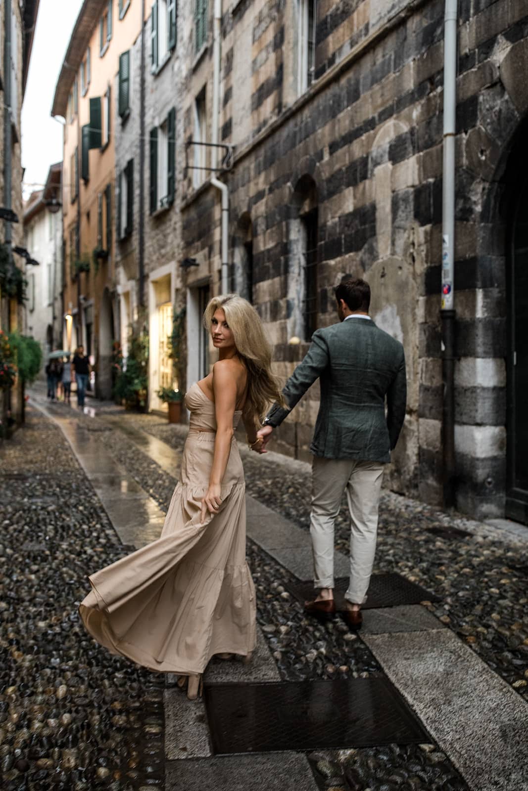 Couple walk in Varenna during Lake Como engagement photos
