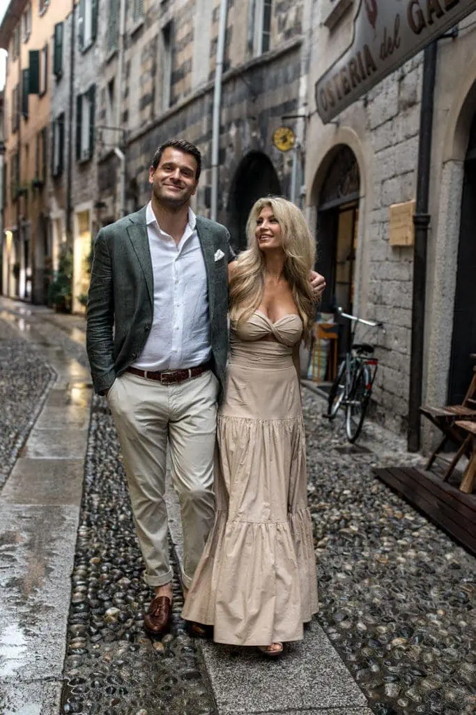 Woman laughs at her fiance while walking in Varenna