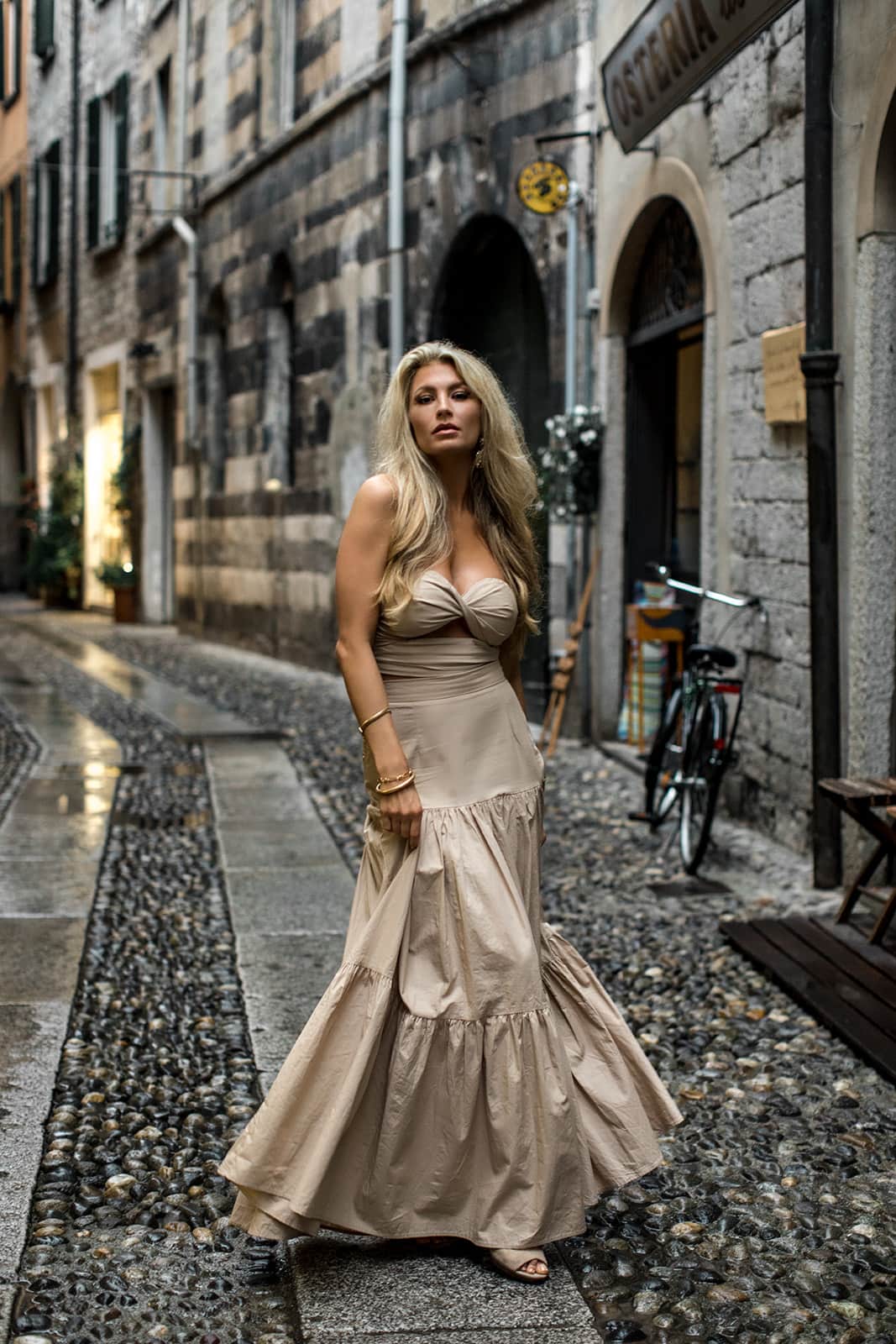Woman twirls her dress in streets of Varenna
