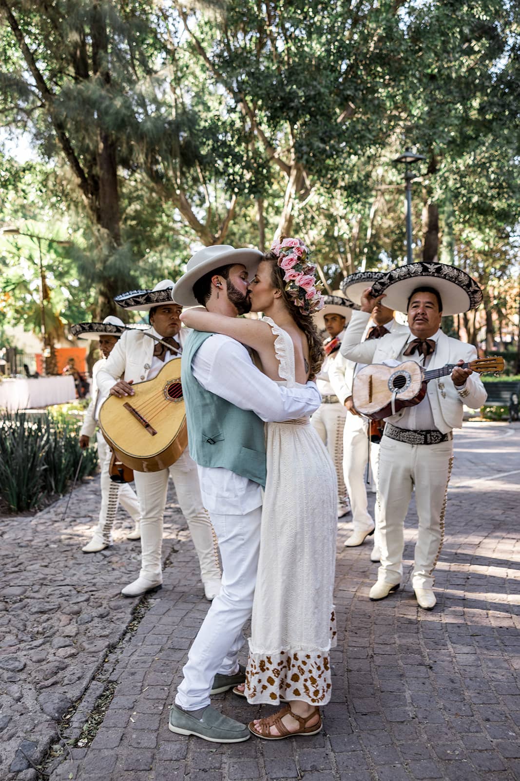 Bride and groom kiss in park in San Miguel de Allende