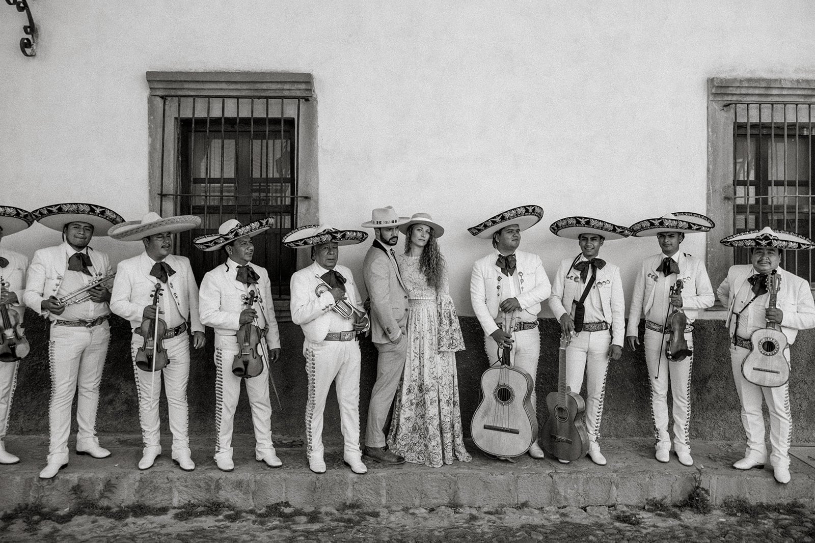 Bride and groom stand with wedding mariachi band in San Miguel de Allende
