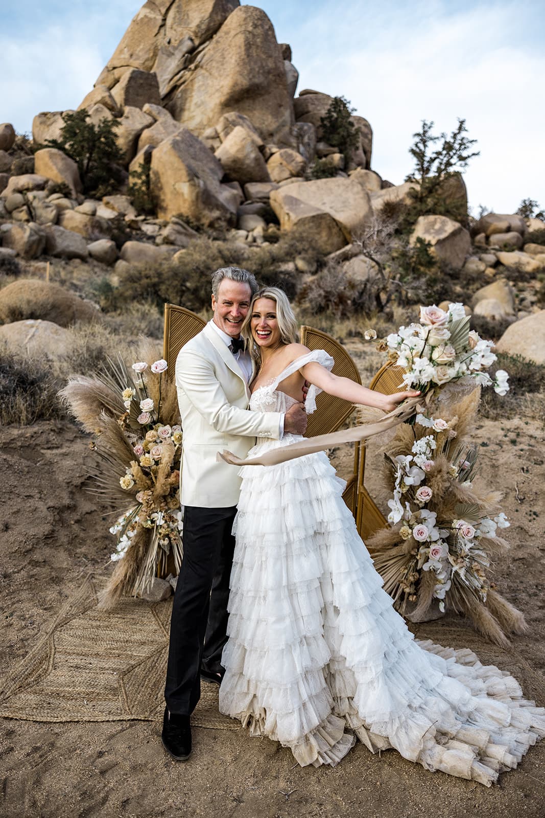 Bride and groom hold each other after getting married during Joshua Tree wedding