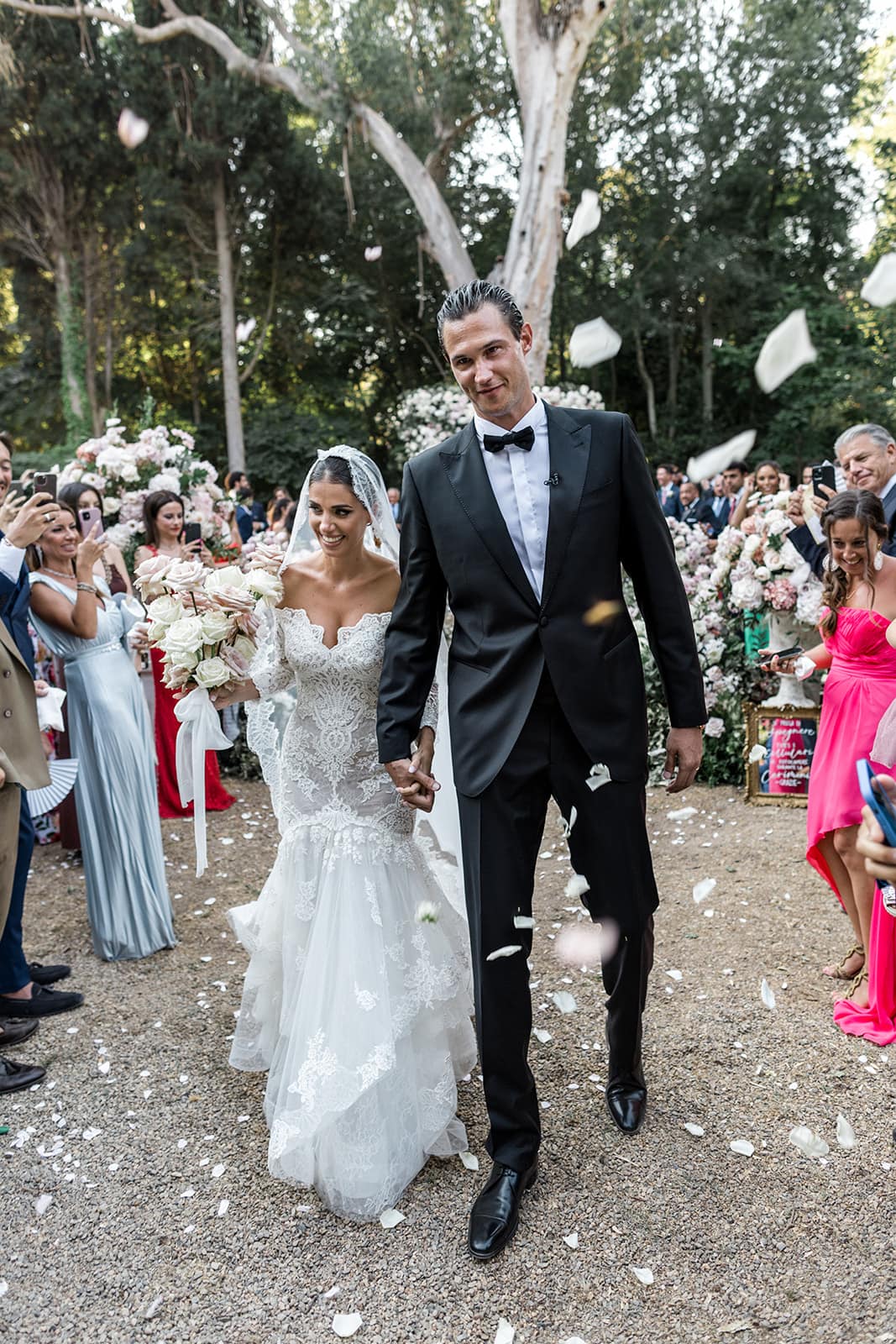 Bride and groom walk down ceremony aisle at Sardinia wedding