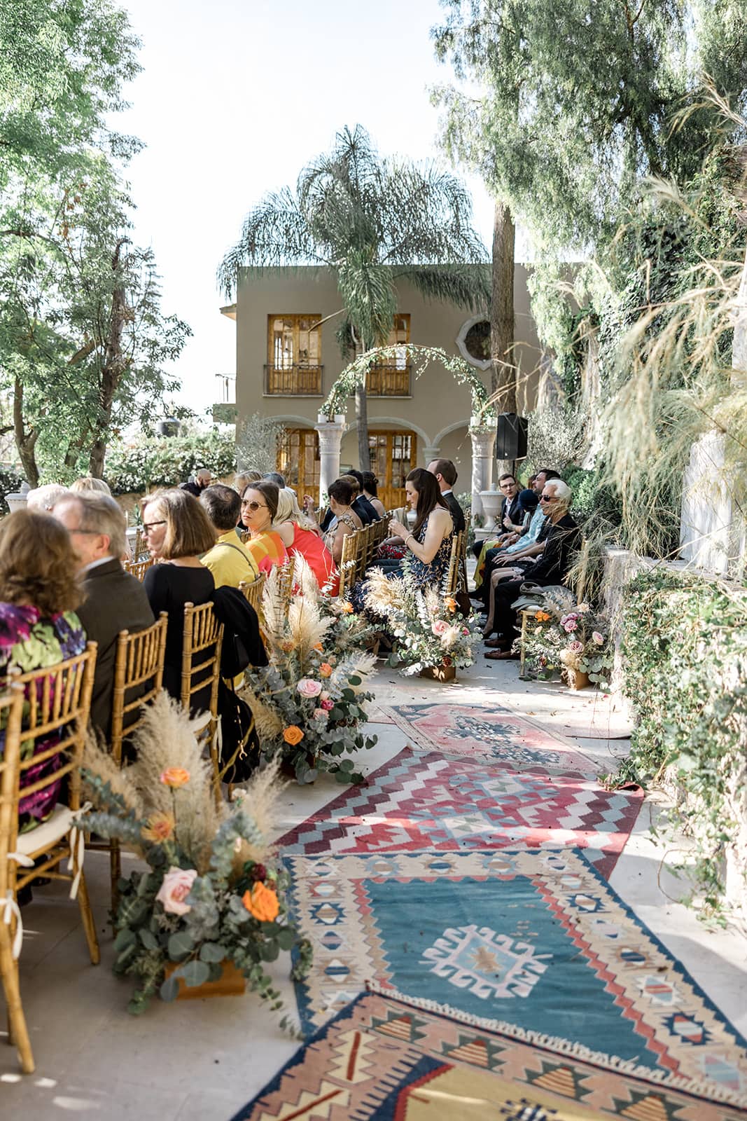Ceremony aisle of Turkish rugs at a wedding in San Miguel de Allende