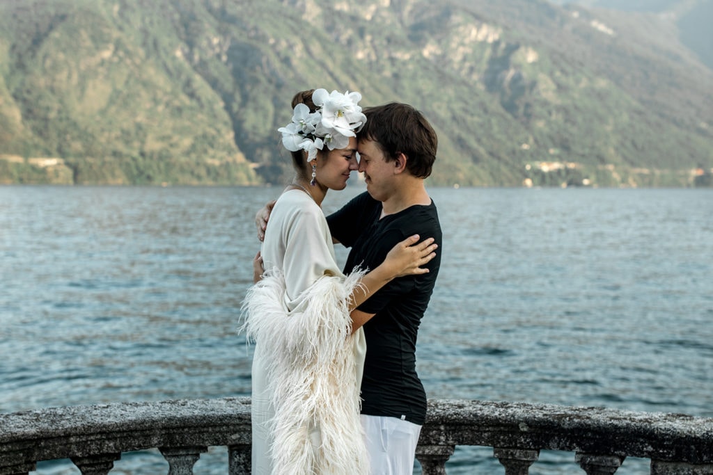 Couple embrace as they overlook Lake Como