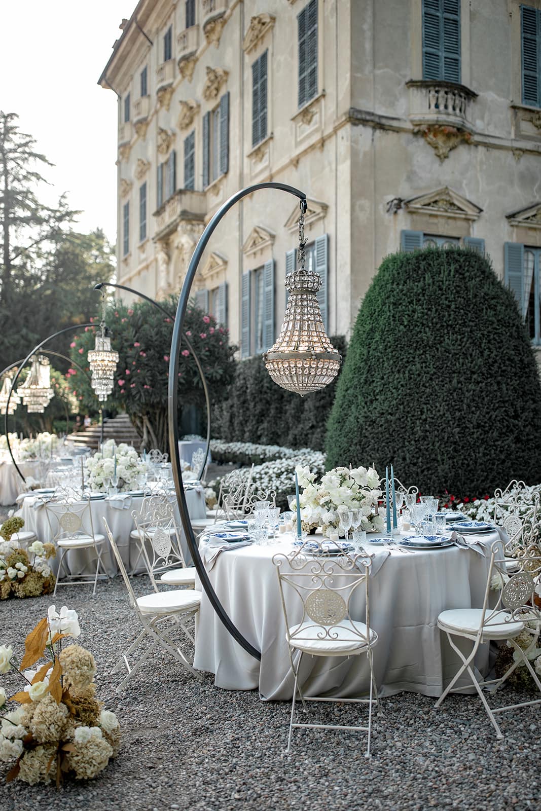 Crystal chandelier hangs over table at Lake Como reception
