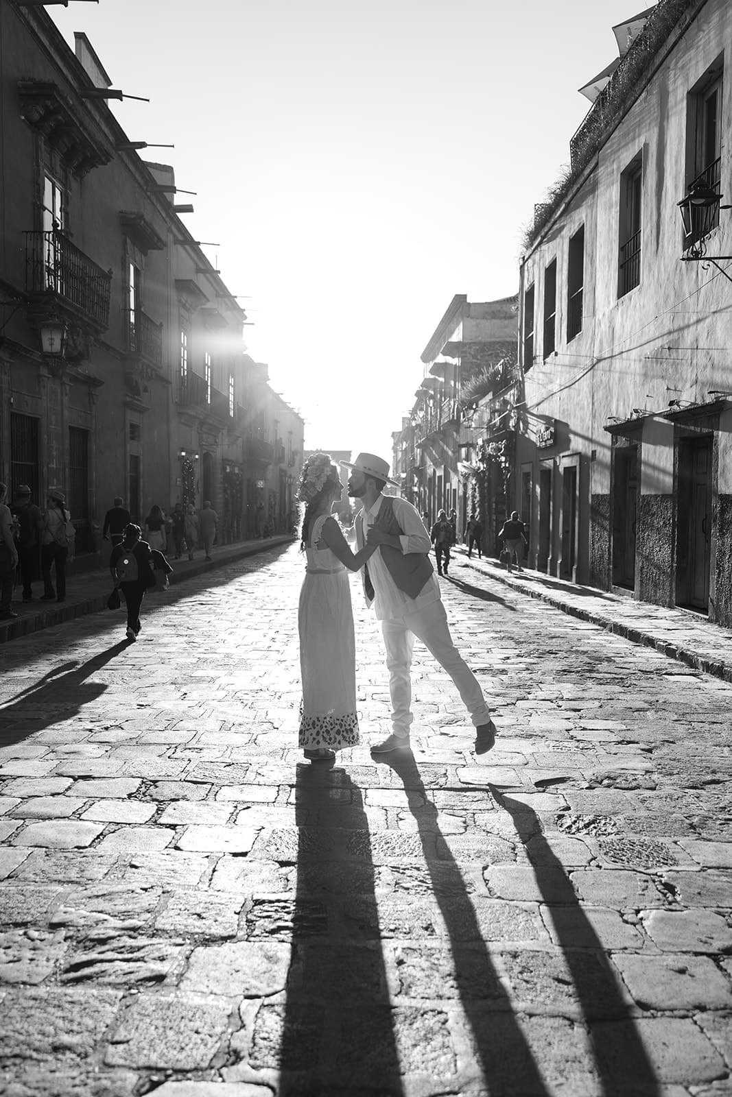 Groom kisses bride on the streets of Mexico