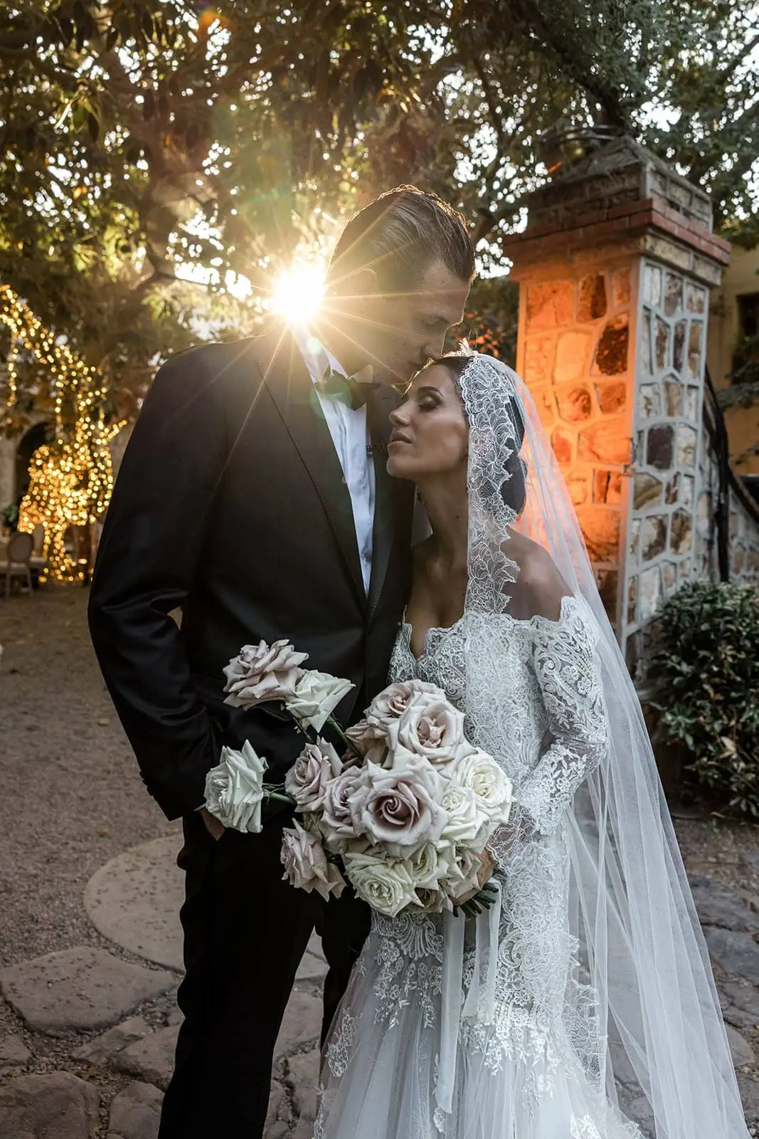 Groom kisses bride's forehead during Villa D'Orri, Sardinia wedding