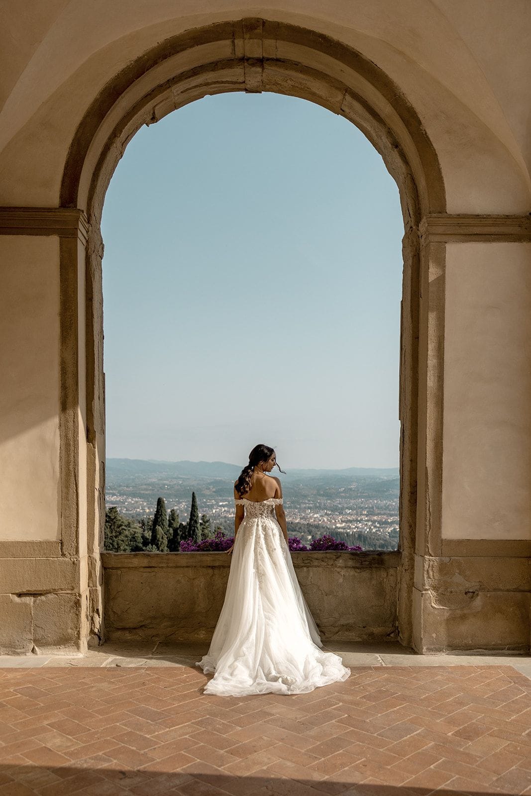 Bride standing in Florence, Tuscany elopement villa archway