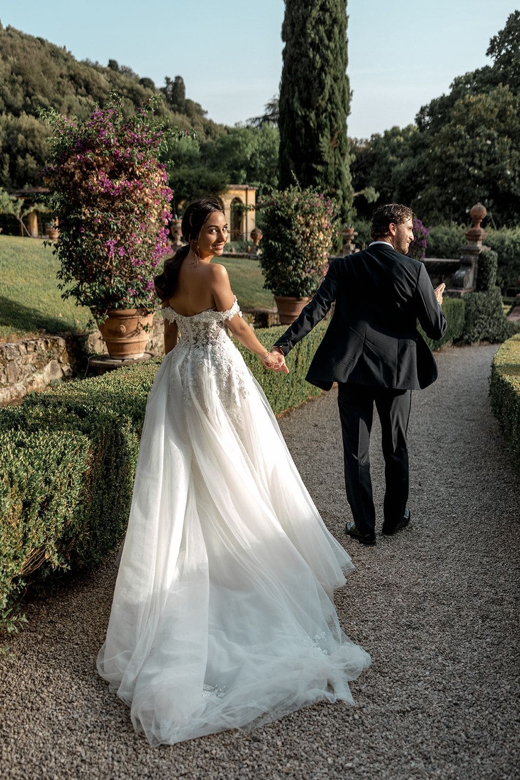 Bride and groom walk grounds of Fiesole elopement venue in Tuscany Italy