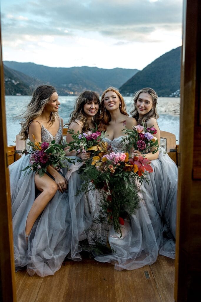 Bride and bridesmaids share a boat tour of Lake Como on the way to the wedding venue