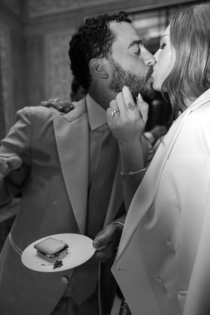Bride and groom kiss after sharing smores at wedding reception