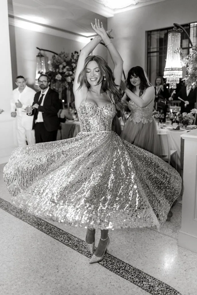 Bride twirling in sparkling dress at Villa Lario wedding reception