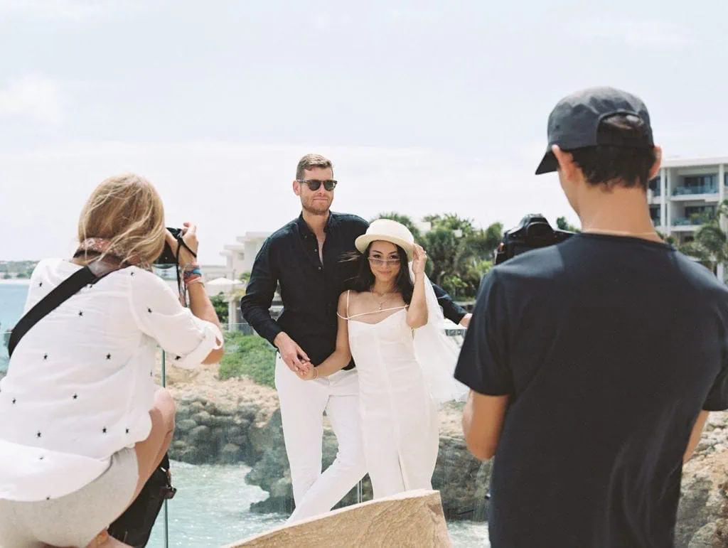 Woman photographs a couple during their multi-day wedding event in Anguilla