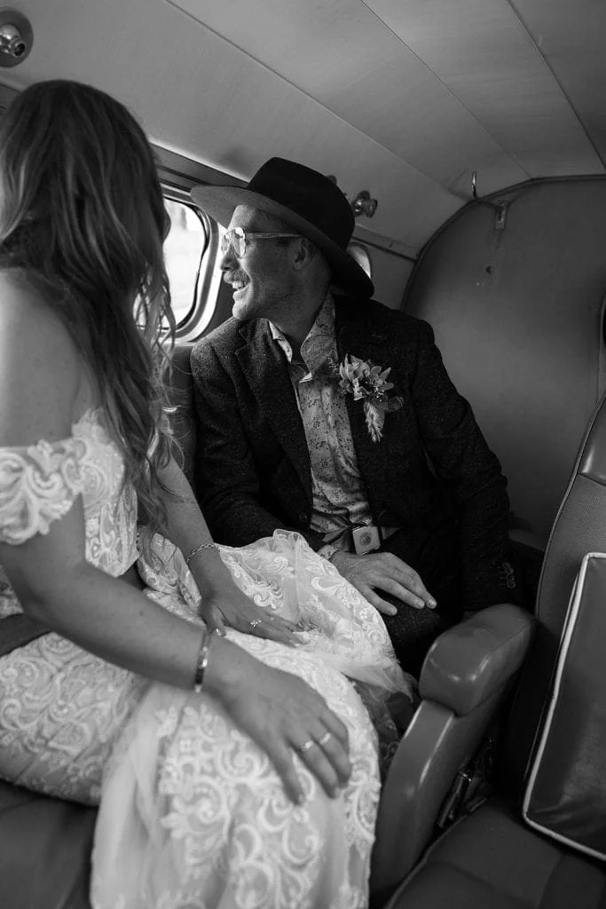 Bride and groom take in the views of Wyoming during their first flight as a married couple