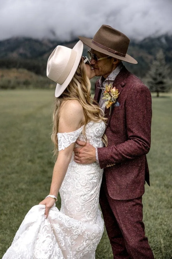 Bride and groom kiss outside at their destination Wyoming wedding