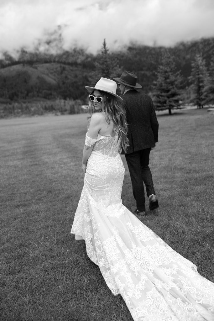 Bride and groom walk in a field during Wyoming destination wedding